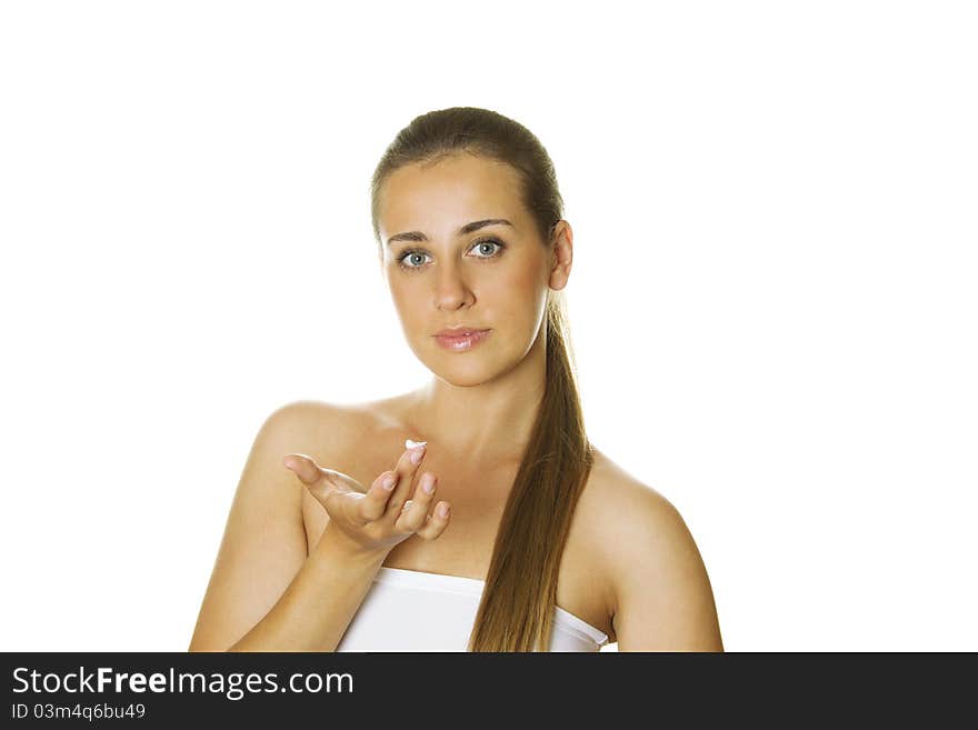 Close-up of a beautiful young woman holding a jar of cream in one hand and the other does not face cream. Close-up of a beautiful young woman holding a jar of cream in one hand and the other does not face cream