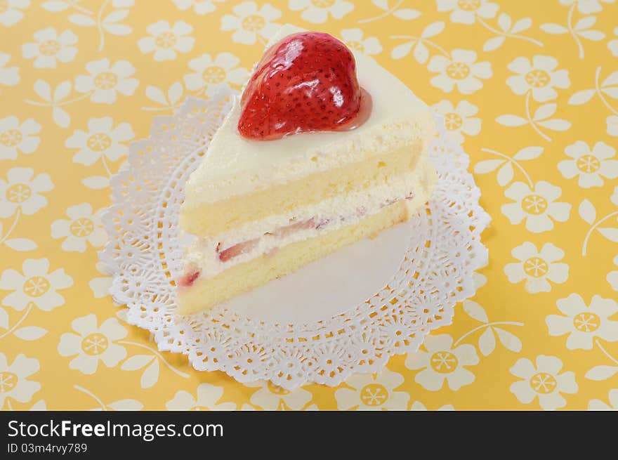 Slide of strawberry soft cake on yellow background.