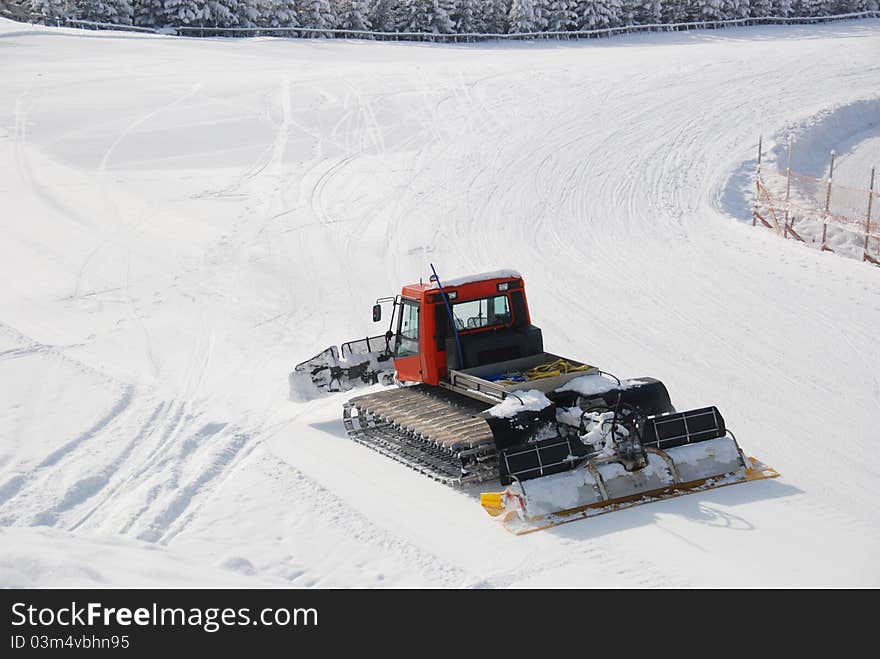 Piste preperation vehicle moving slowly over piste, making it even again. Piste preperation vehicle moving slowly over piste, making it even again