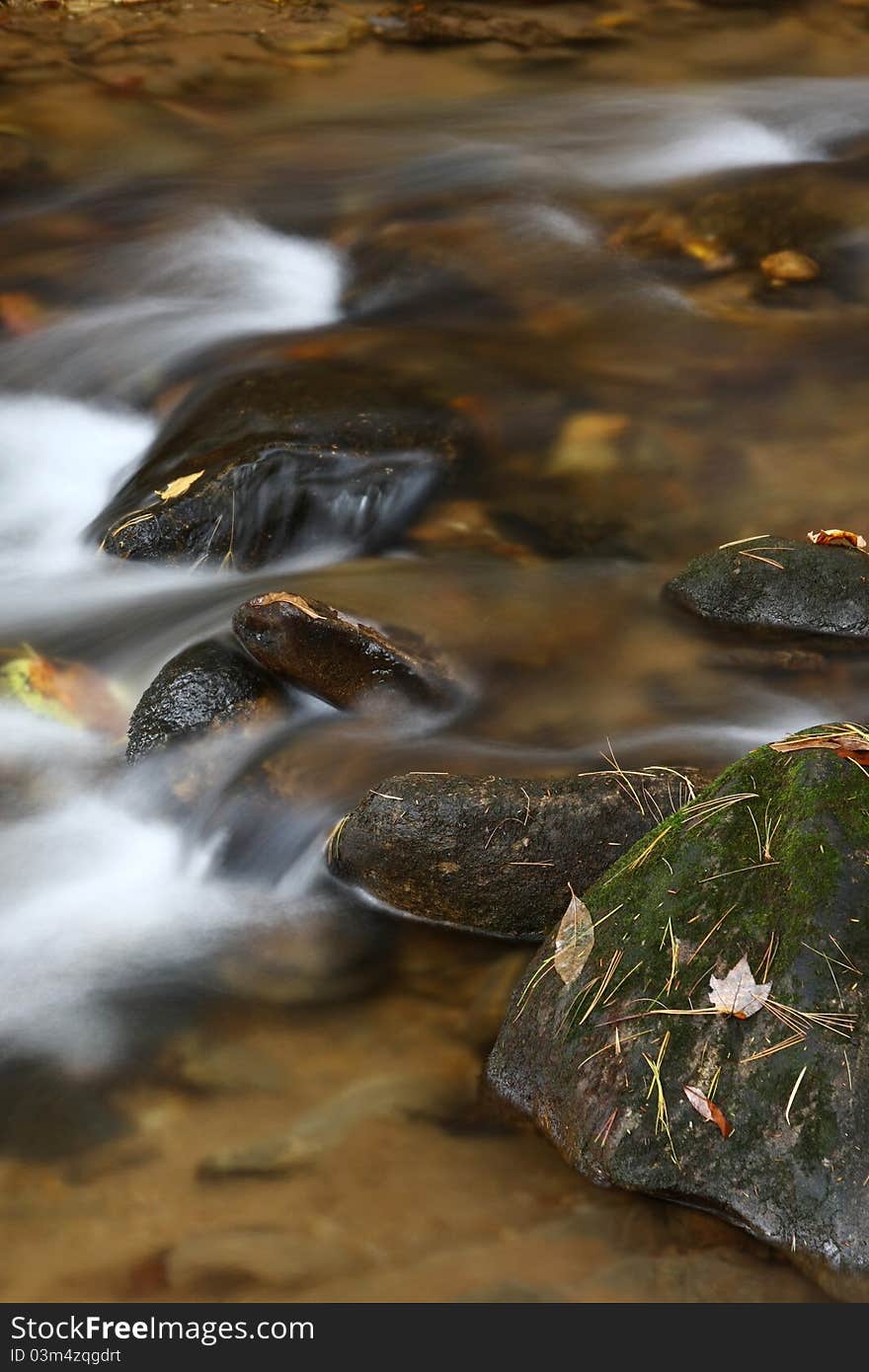 The rocky rapids in a river in the fall. The rocky rapids in a river in the fall