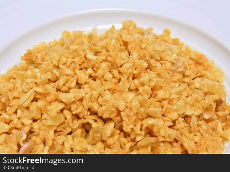 Fried garlic on white plate