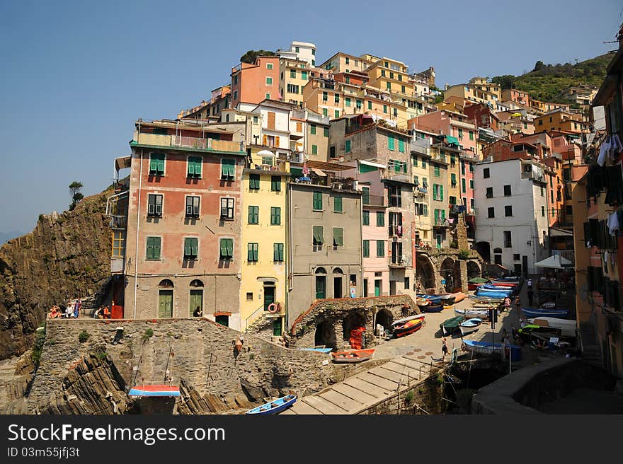 The colourful buildings around the tiny harbour of Riomaggiore, one of the stunningly beautiful Italian Cinque Terre villages and a UNESCO world heritage site. The colourful buildings around the tiny harbour of Riomaggiore, one of the stunningly beautiful Italian Cinque Terre villages and a UNESCO world heritage site.