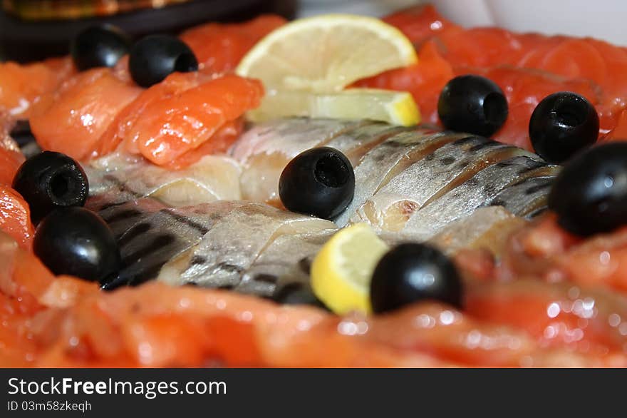 Cutting the fish, lemon and olives