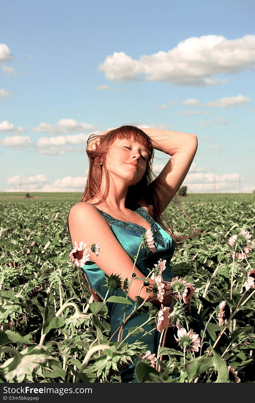 Girl standing on the sunflower field. Girl standing on the sunflower field