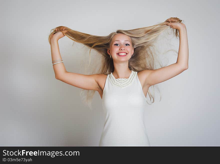 Energetic fresh portrait of young woman against a white background. Energetic fresh portrait of young woman against a white background