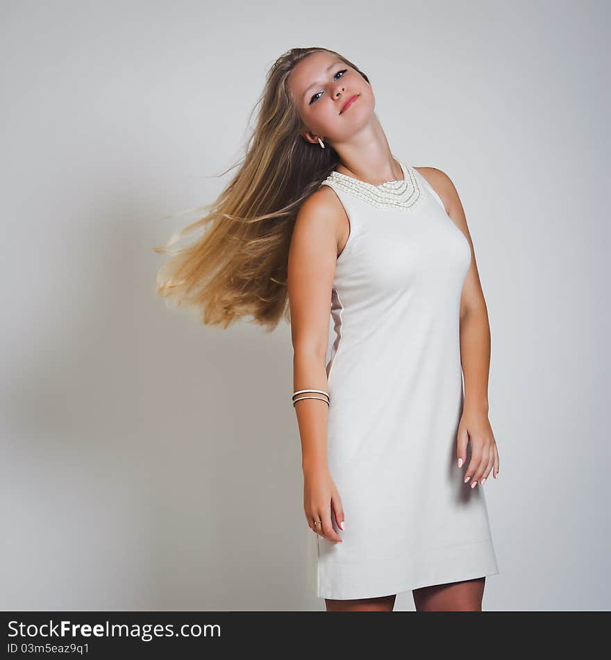 Portrait of attractive woman with developing hair against a white background