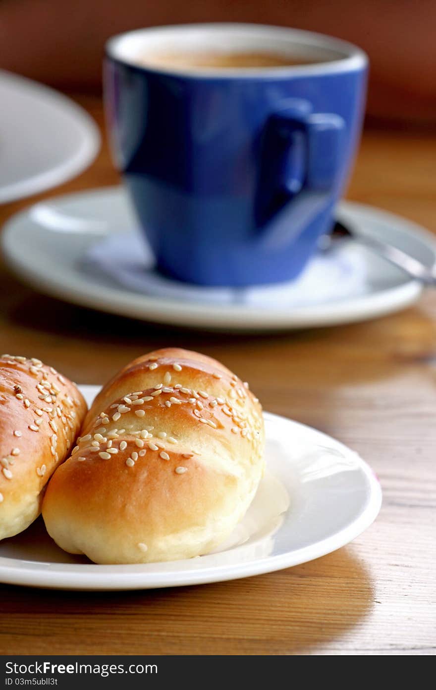 A bread and coffee on the table