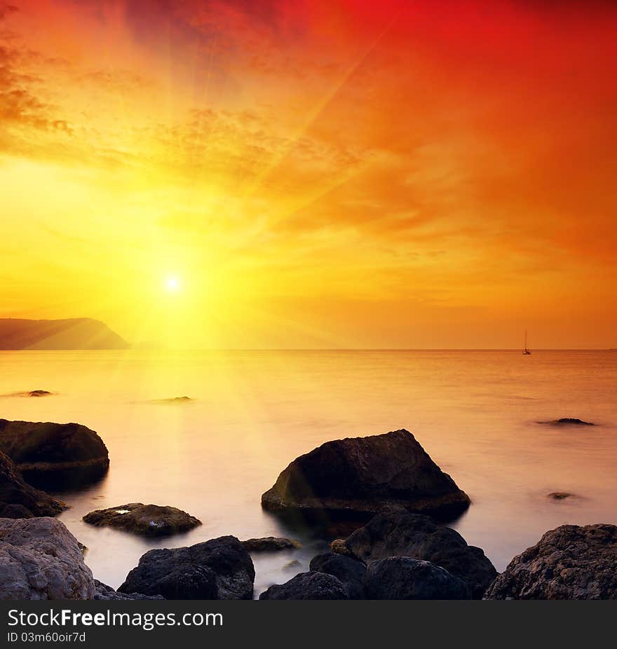 Sea landscape with a sunset and the cloudy sky