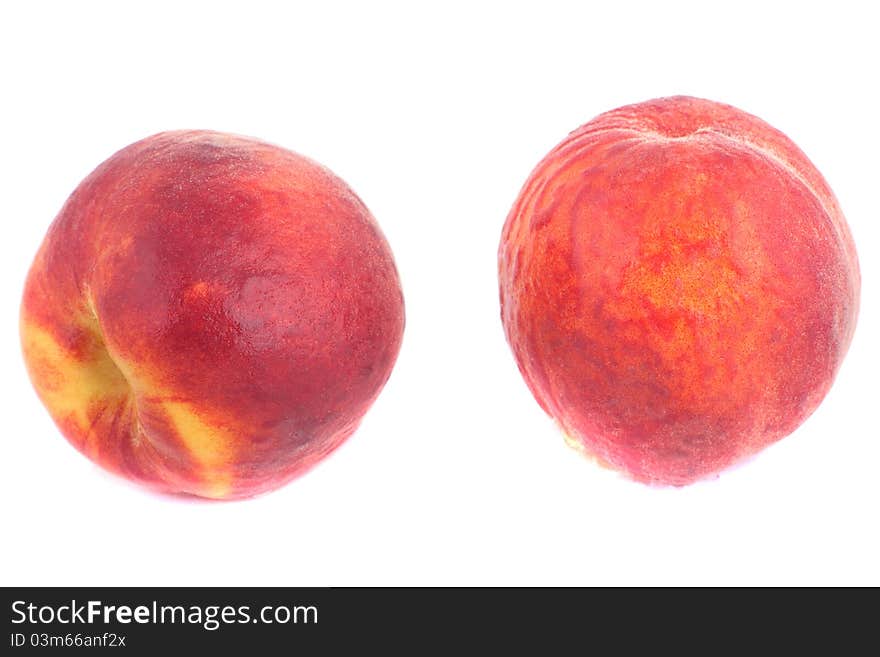 Two sweet peaches with water drops