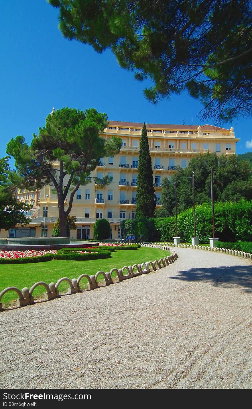 Yellow hotel and park path. Yellow hotel and park path