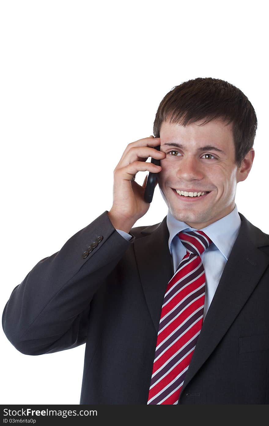 Pleased banker listens to good news on mobile phone. Isolated on white background.