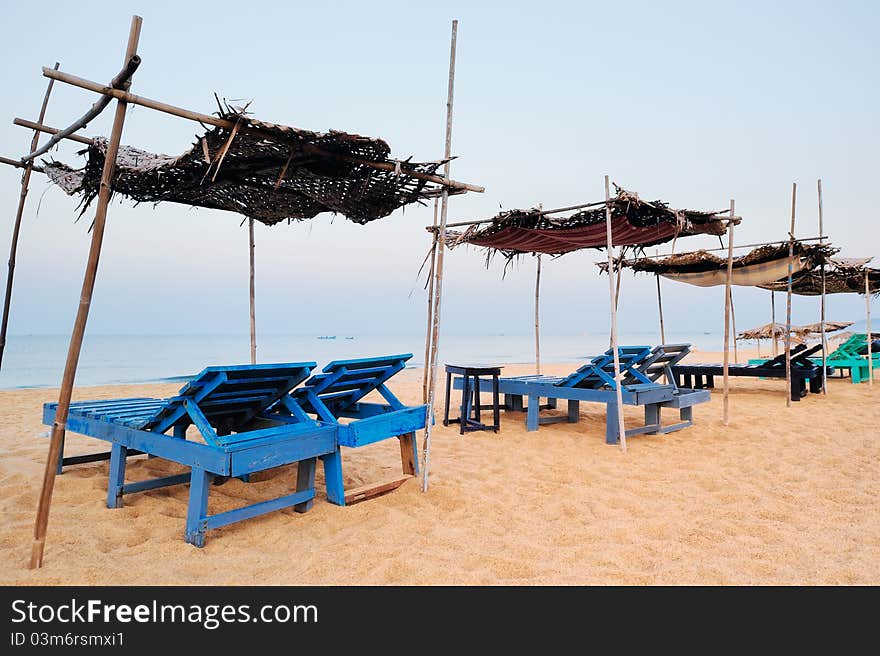 Exotic parasols and deck-chairs on tropical coast