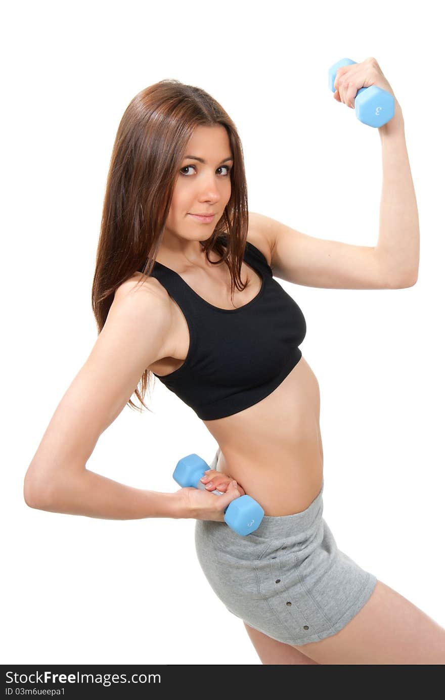 Fitness woman instructor weightlifting with perfect athletic body and abs working out with weights dumbbells in gym isolated on a white background