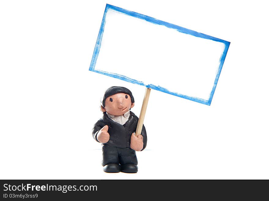 Little businessman made of modelling clay wearing a suit with thumb up holding a blank sign. Little businessman made of modelling clay wearing a suit with thumb up holding a blank sign.