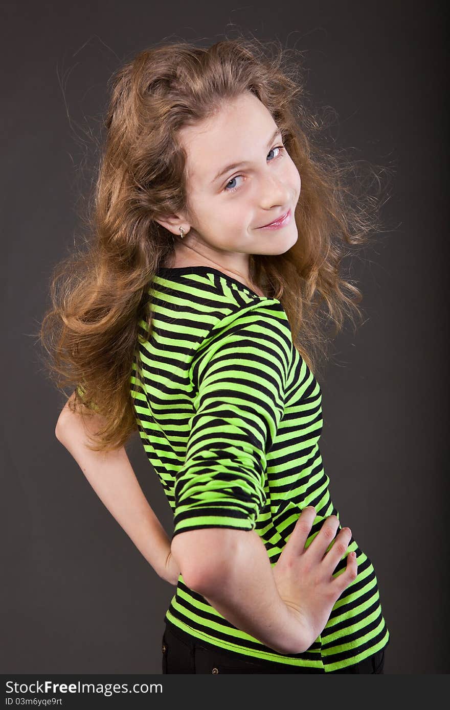 Portrait of happy girl teenager in studio