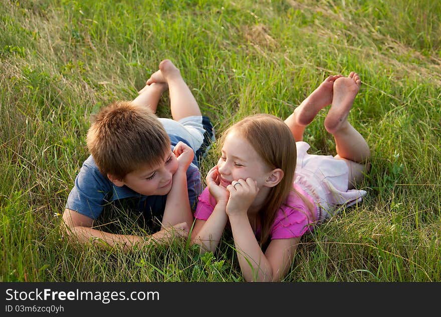 Funny Boy and girl on grass