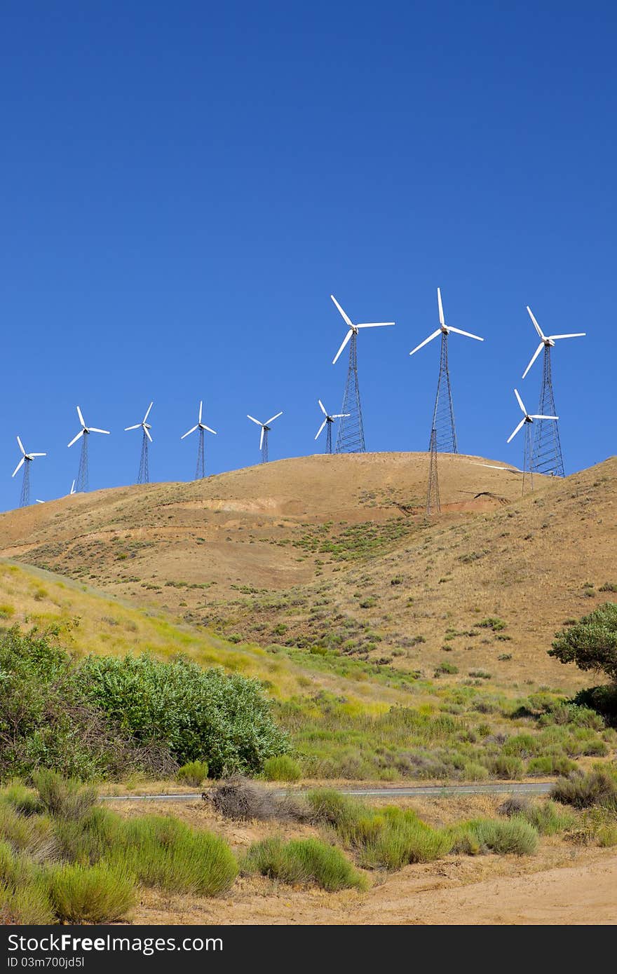 Wind turbines on top of a hillside. Wind turbines on top of a hillside.