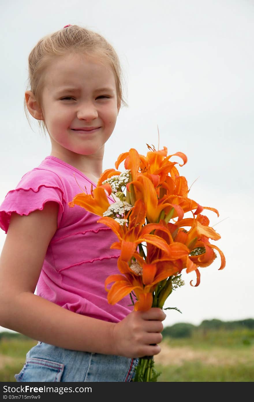 Girl with a bouquet of orange lilies. Girl with a bouquet of orange lilies