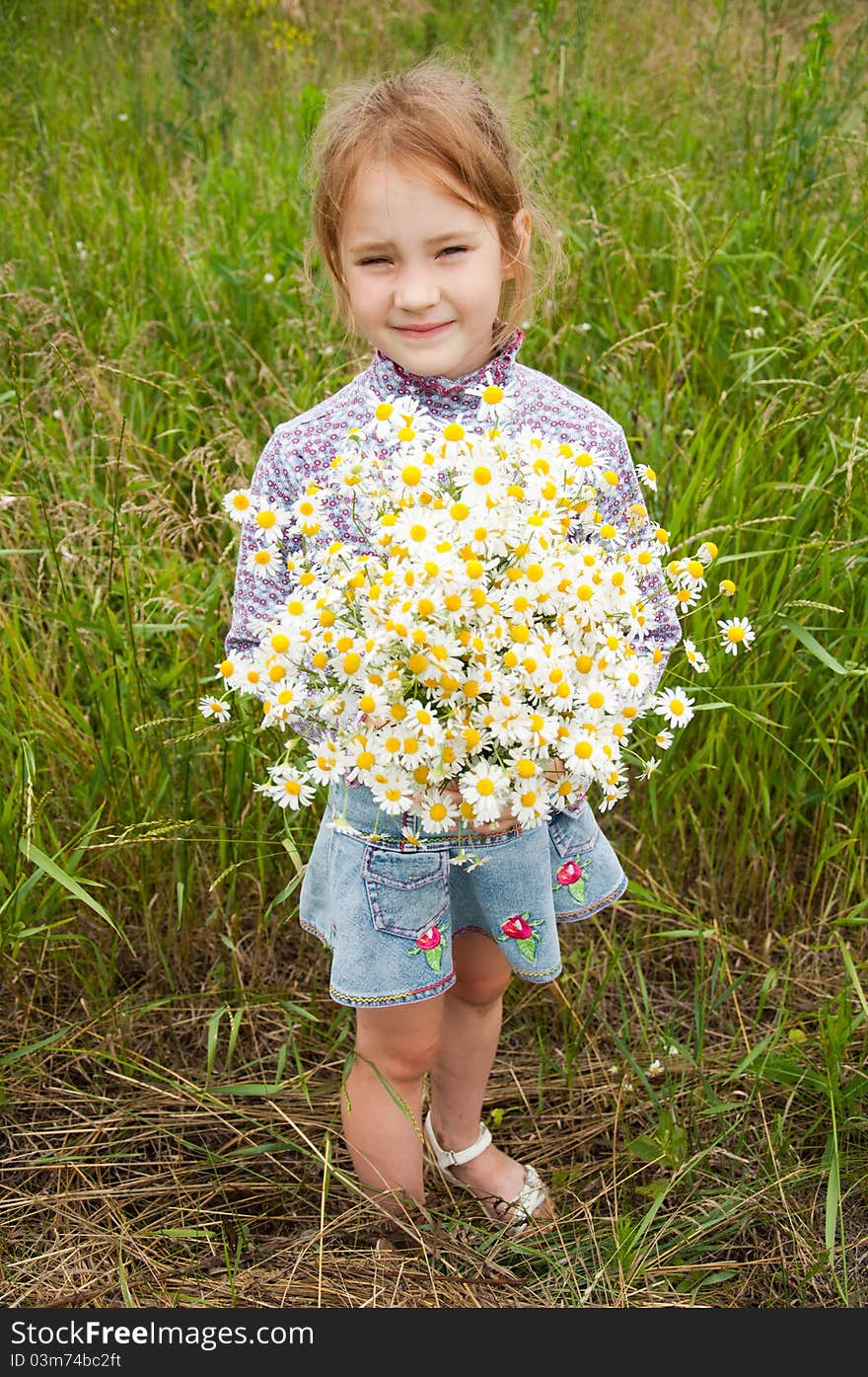 Girl with a bouquet of daisies field