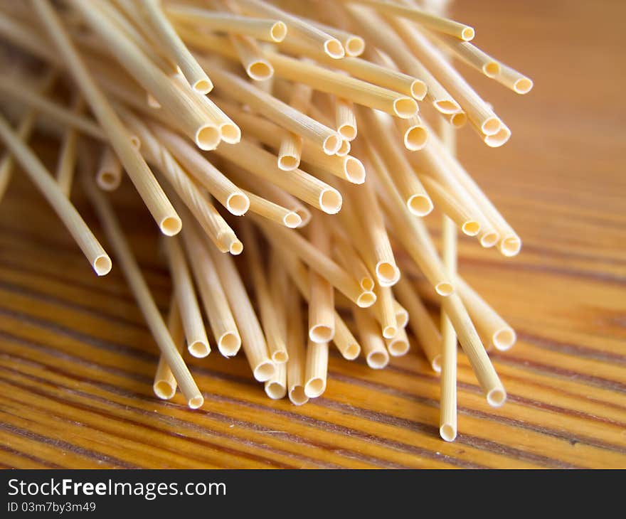 Wheat stalks on a wooden table in the form of tubes abstraction. Wheat stalks on a wooden table in the form of tubes abstraction