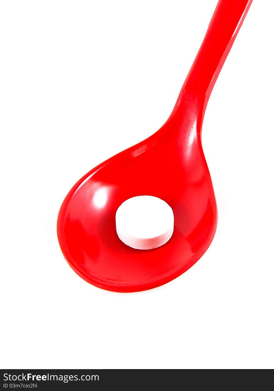 A medicine on red spoon isolated