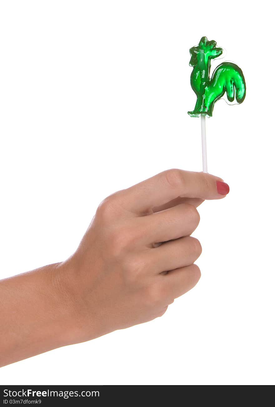 Lollipop in a hand isolated over white background