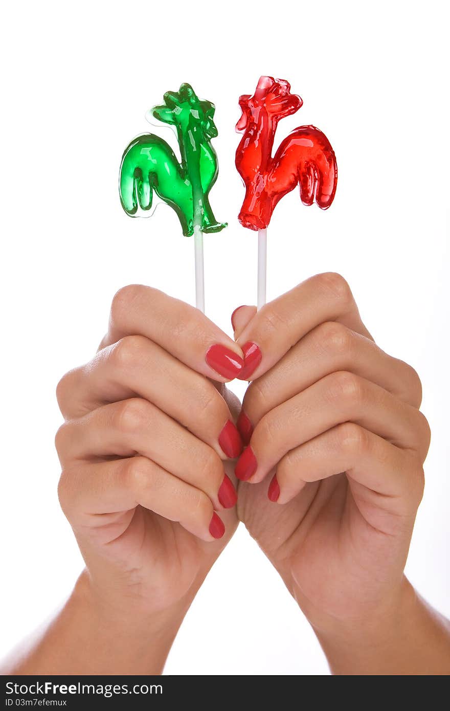 Lollipop in a hand isolated over white background