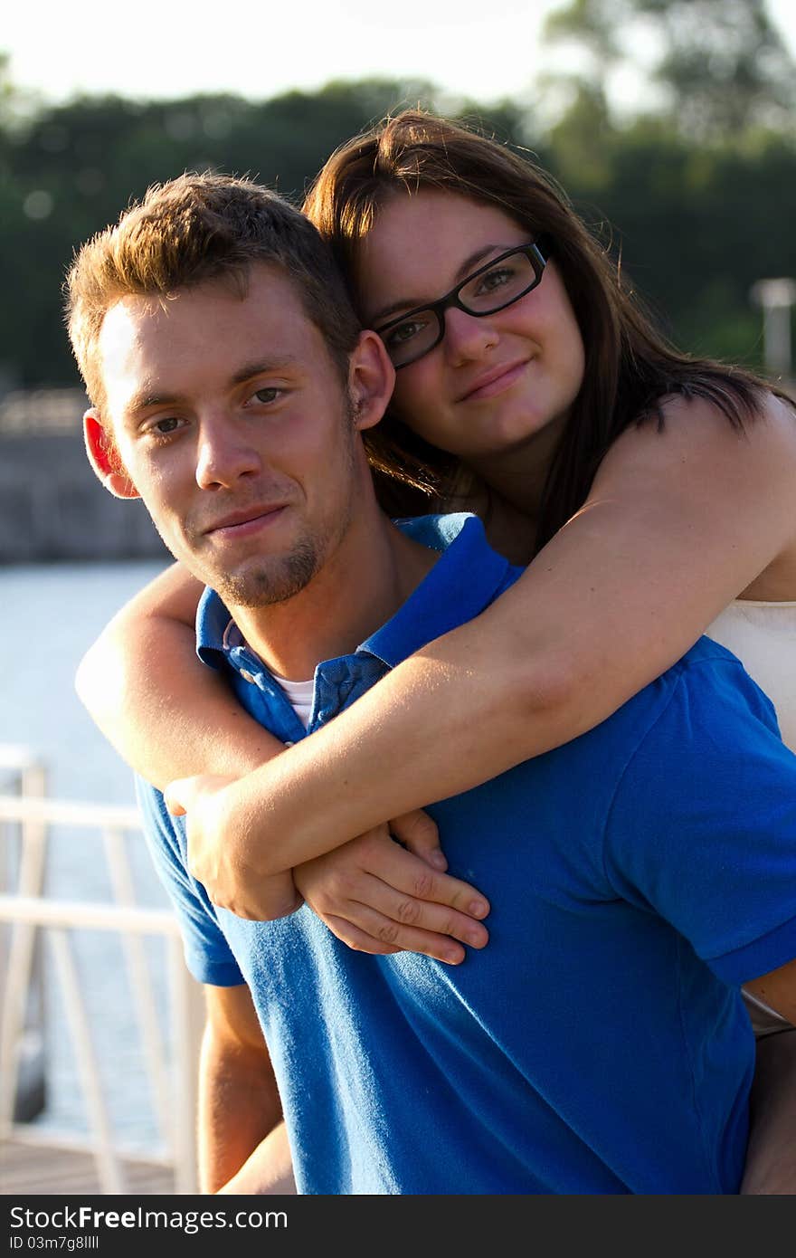 A teenage girl piggybacks on her boyfriends back. A teenage girl piggybacks on her boyfriends back.