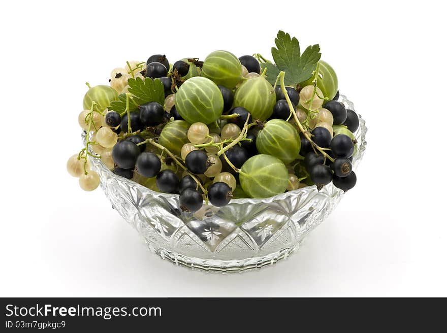 A Glass Dish Full of Gooseberies and Currants on the White Background