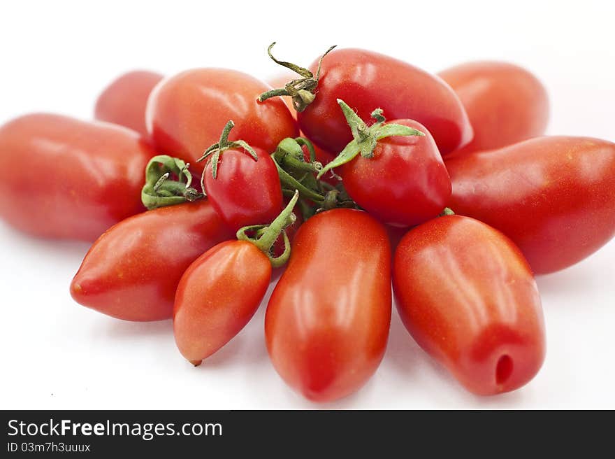 Organic Tomatoes Beside Each Other on the White Background. Organic Tomatoes Beside Each Other on the White Background