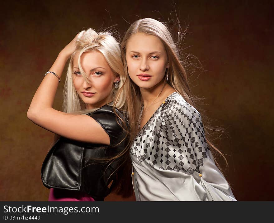 Two pretty women on a colored background