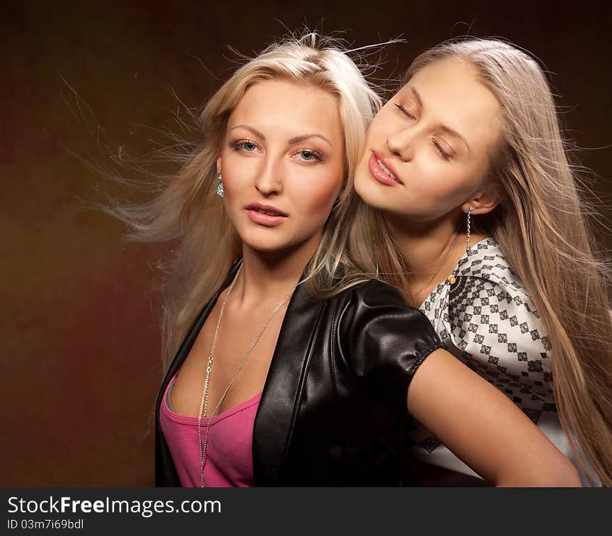 Two beautiful women on a colored background