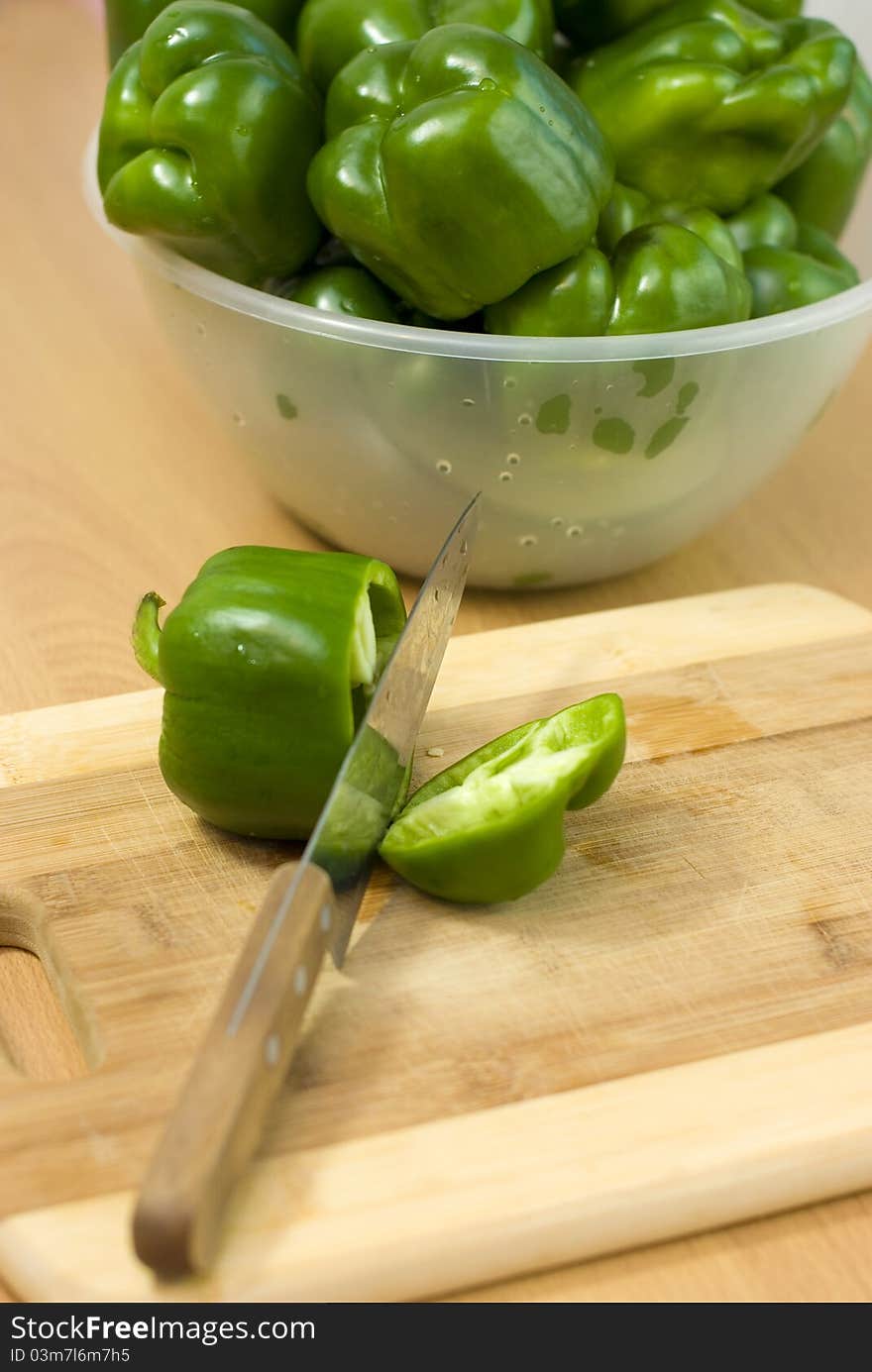 Fresh green pepper cut with a knife