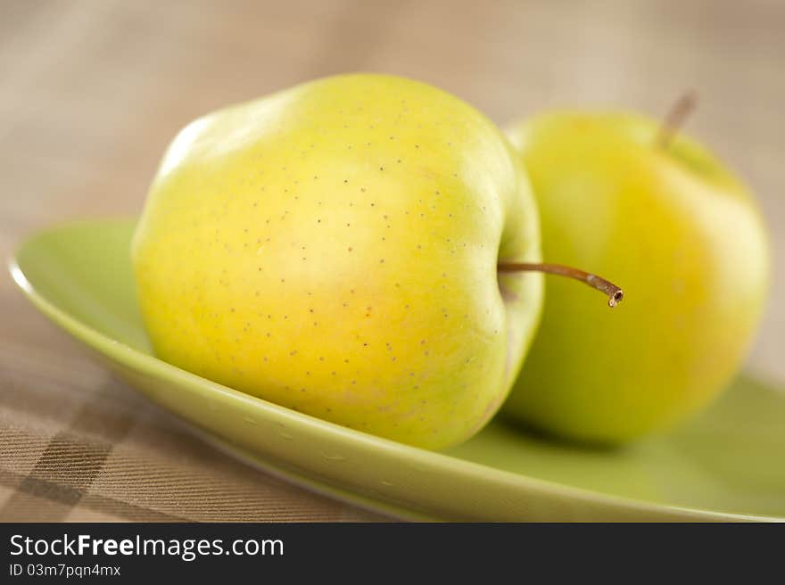 Closeup of fresh green apple on plate