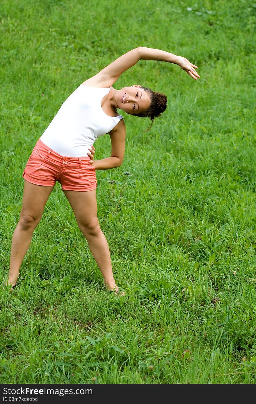 Girl doing exercises in park