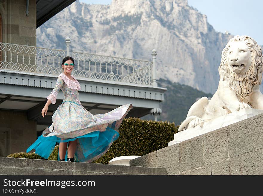 Woman in dress standing near the palace