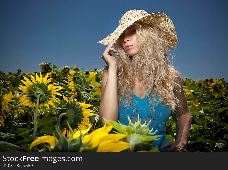 Blond girl in sunflowers