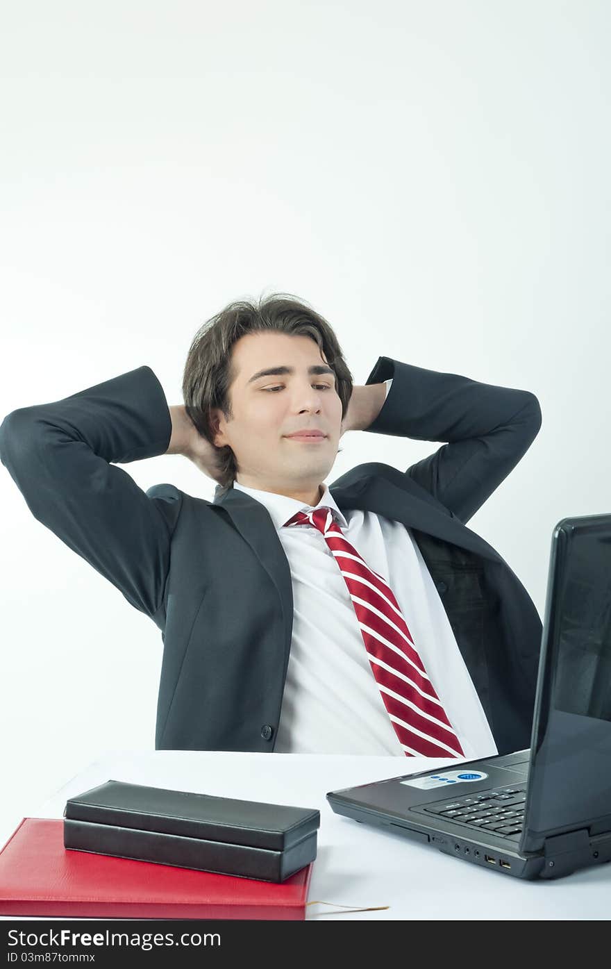 Relaxed business man watching his laptop on a white background. Relaxed business man watching his laptop on a white background