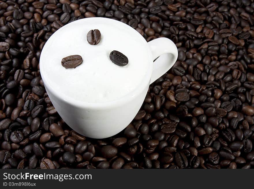 Glass of hot cafe latte on coffee bean background. Glass of hot cafe latte on coffee bean background.