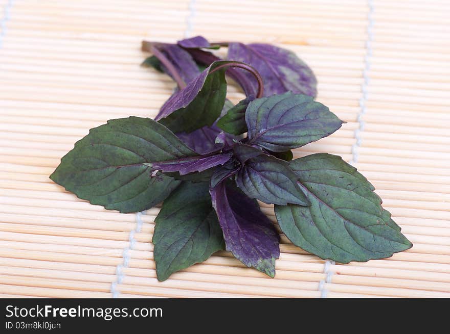 Fresh basil on a bamboo mat