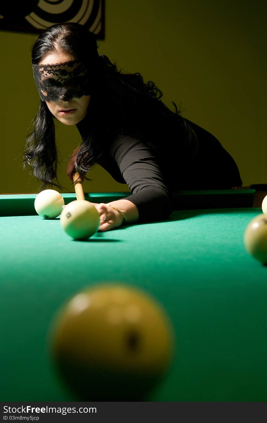 Woman plays billiards