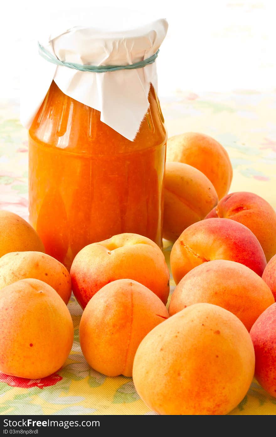 Apricot jam in the pot and fresh ripe apricots