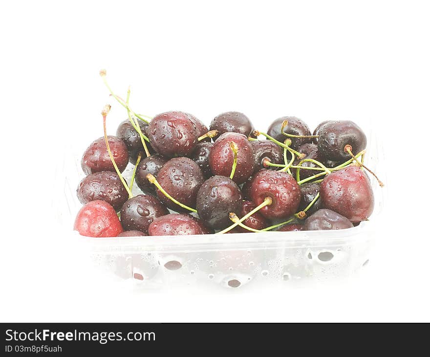 Red cherries in plastic tray