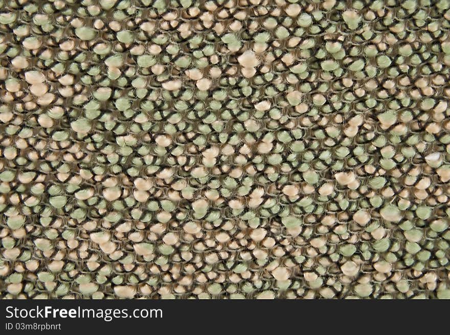 The sample of a carpet fabric. a rough background from a fabric. The sample of a carpet fabric. a rough background from a fabric