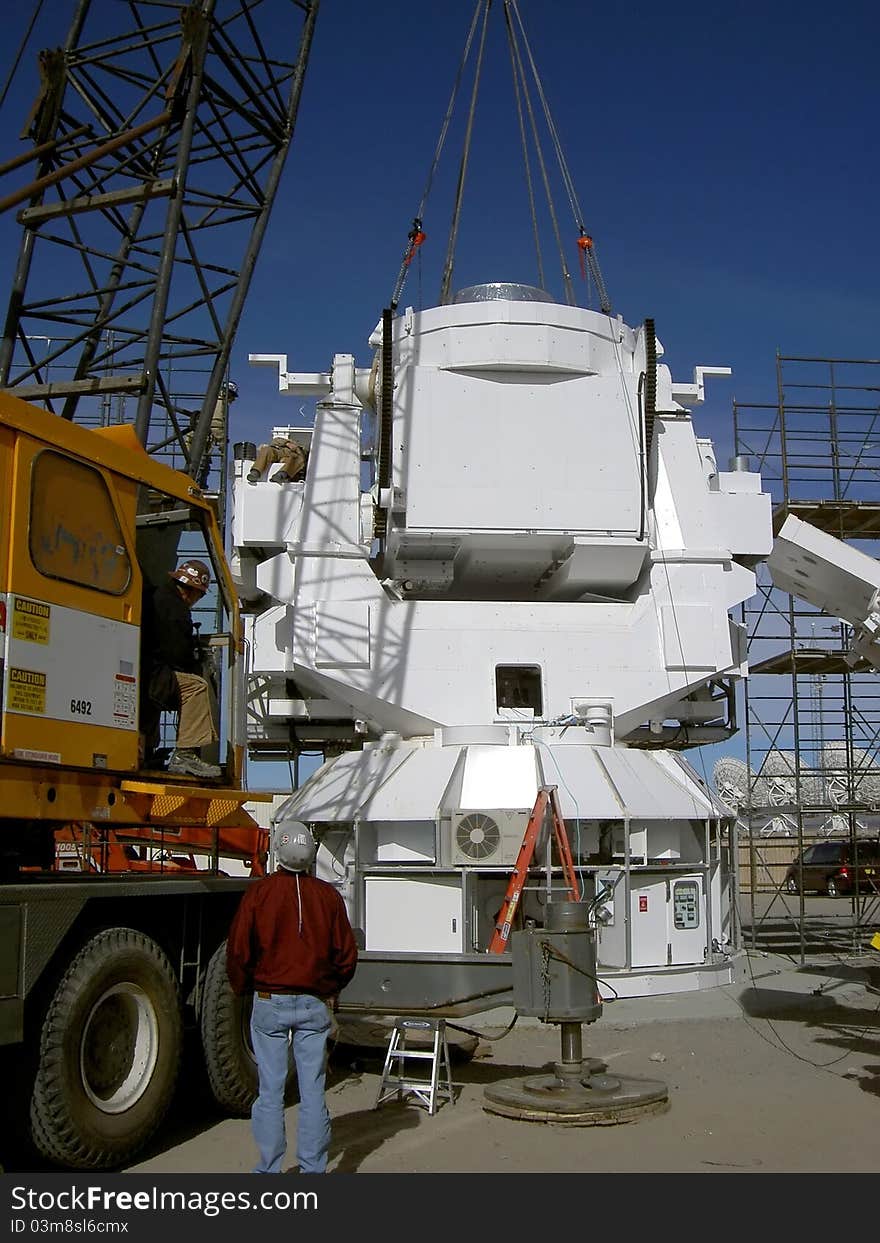 Crane installing observatory base