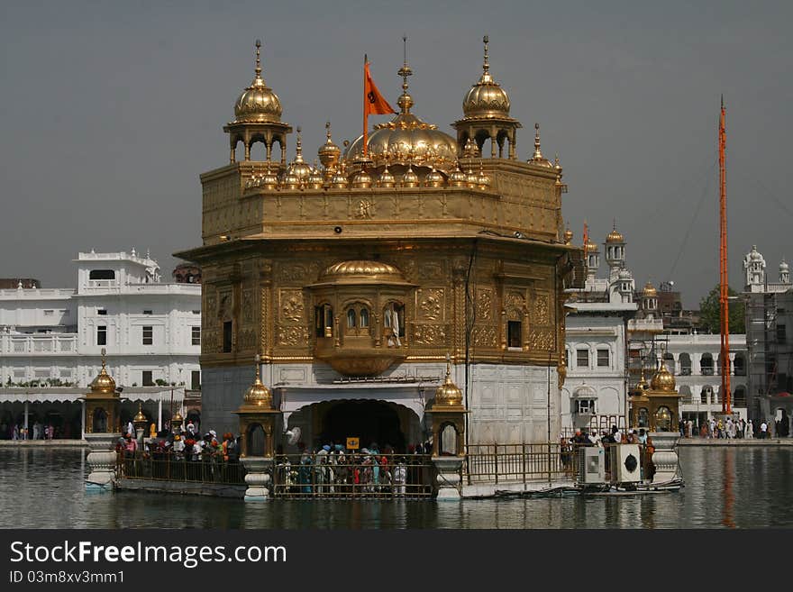 Golden Temple at Amritsar with pilgrims giving worship and prayer