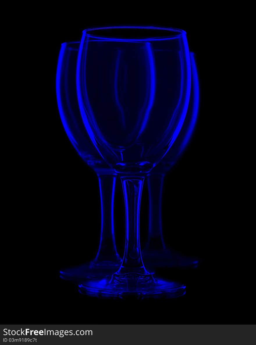 Three empty wine glasses on black