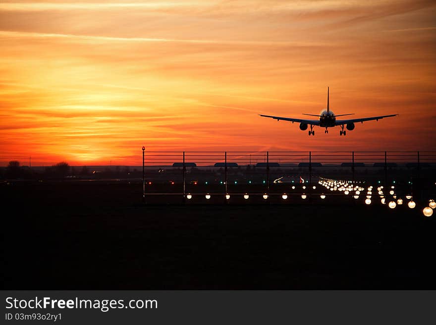 Aircraft touch down at sun down. Aircraft touch down at sun down