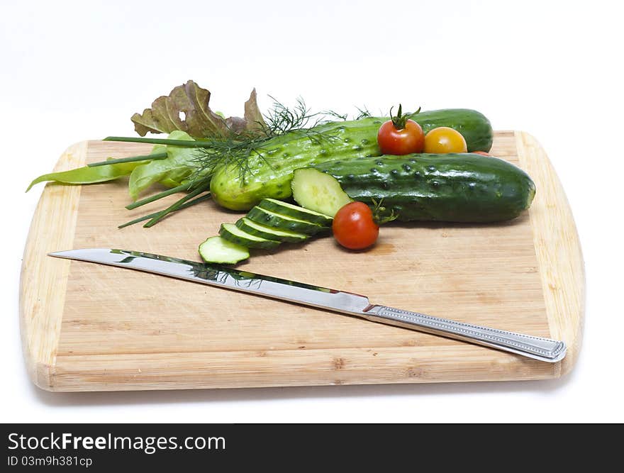 Fresh cut cucumbers with other vegetables. Fresh cut cucumbers with other vegetables