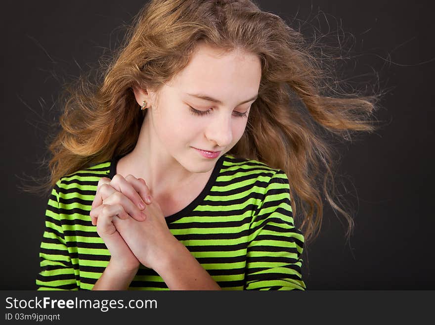 Portrait of happy girl teenager in studio